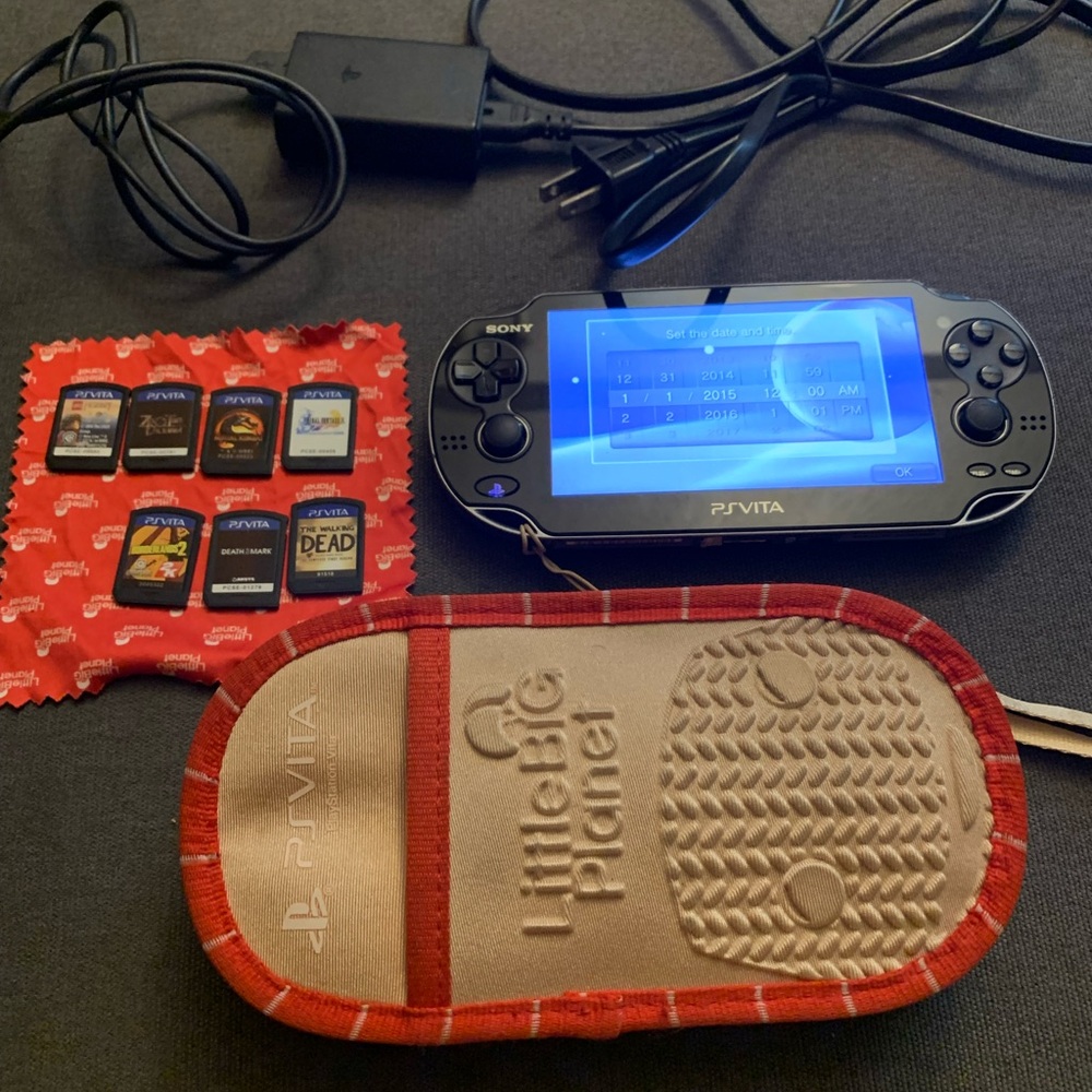 Sony PS Vita 1000 Console with games, 8GB Memory card, and adapter